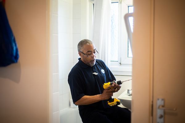 Handyman installing housing adaptation