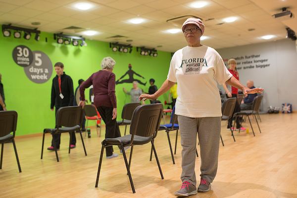 Elderly people doing a strength and balance class.