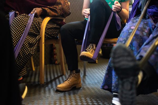 A person using a resistance band with their foot