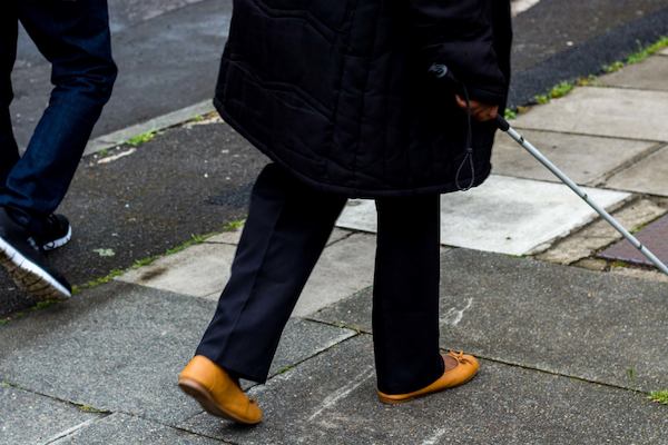 Person walking with walking stick