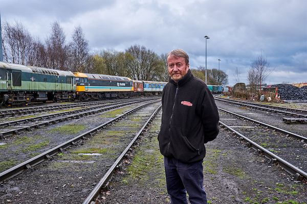 Man standing in front of train