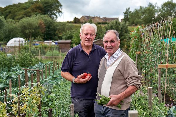 two male gardeners in a community allotment