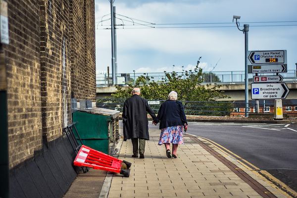 Older couple walking in street