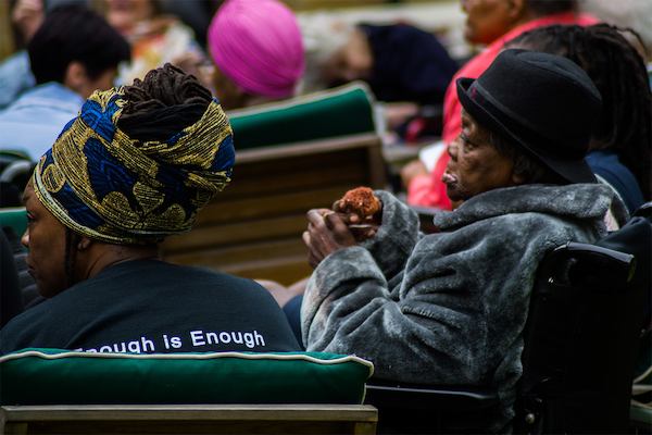 Two women sitting in chairs outside