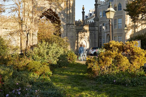 A pair of people walking by a church