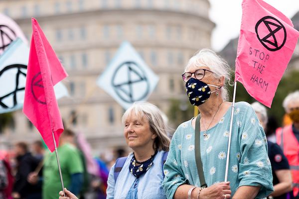 Older pair protesting with signs