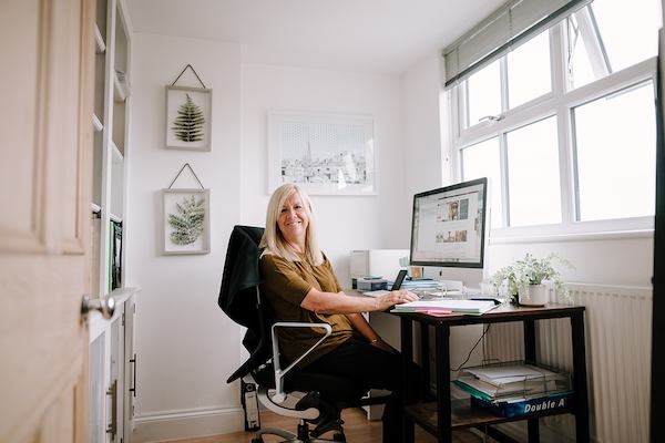 Older worker sitting by desk