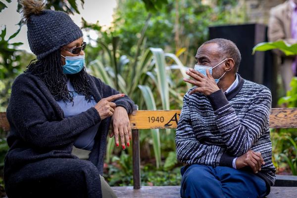 two older people talking outside