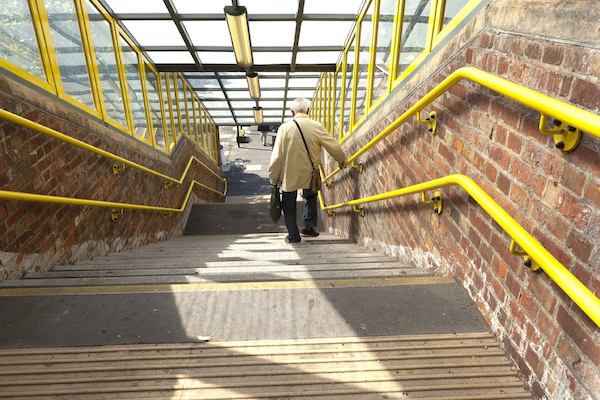 older man walking down stairs