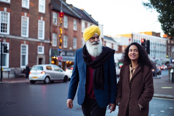 older man walking with younger woman