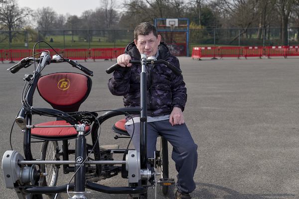 Dave sitting on a side by side bicycle