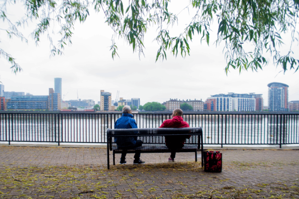 Two BAME people sitting on a bench