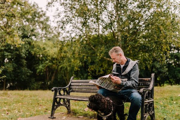 older man reading a newspaper