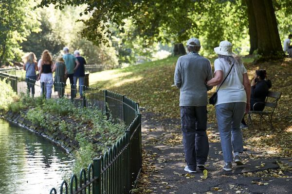 group of older people walking in a park
