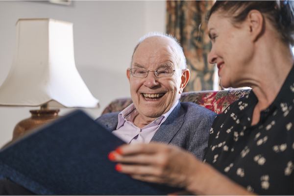 older man and woman reading together