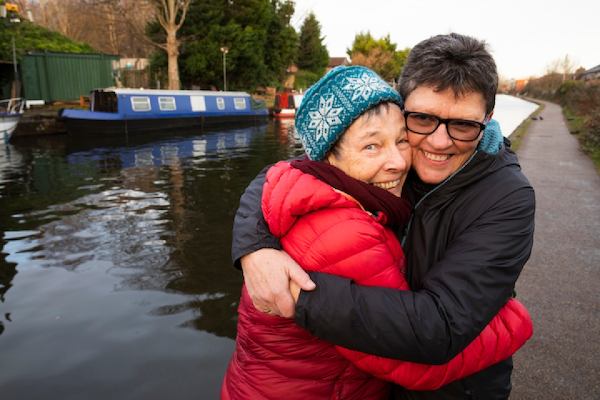 Jo and Liz hugging each other by a canal