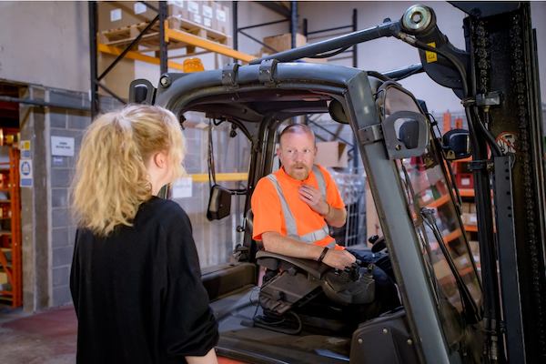 Two older workers in a warehouse