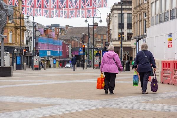 2 women walking down a street