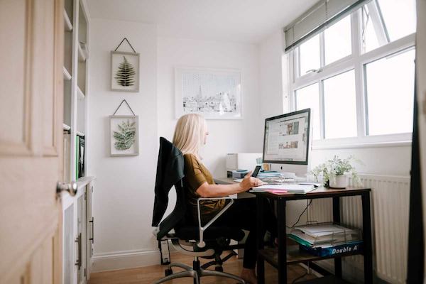 Blonde woman working at computer
