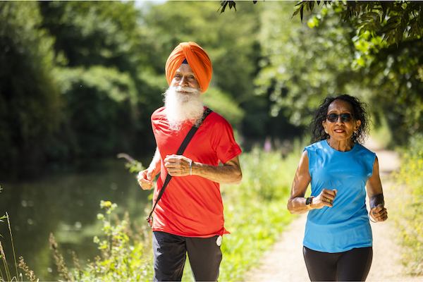 Two older people running