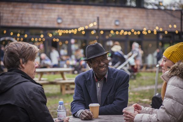 People sitting round the table having coffee and laughing