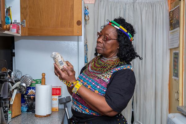 Older woman in kitchen looking at ingredients