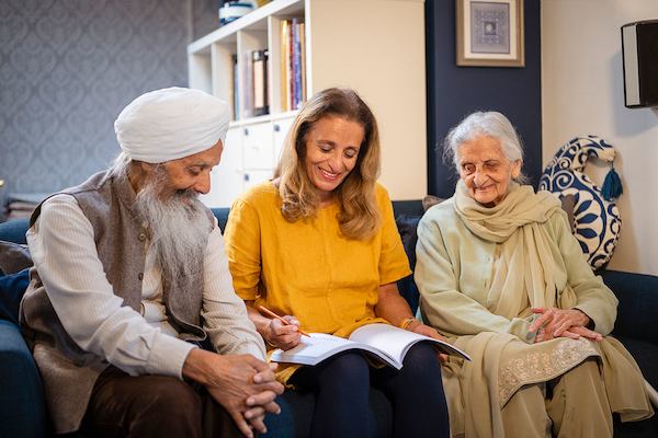Three older people on a sofa