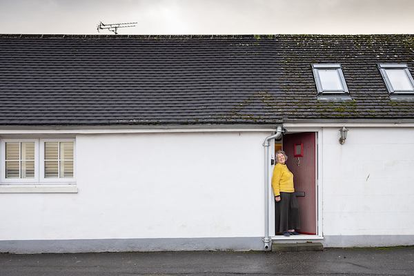 Older woman in house doorway