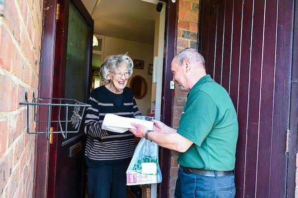 Older-man-delivering-shopping-to-an-older-woman