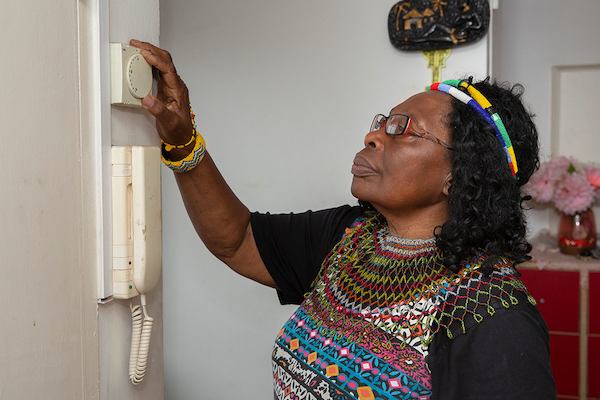 Older-woman-using-thermostat