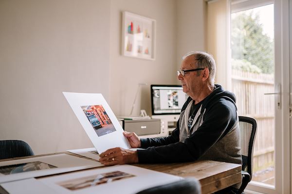 Older-man-looking-at-photos