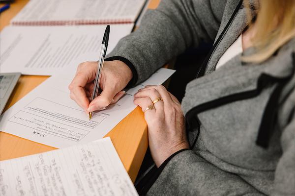 Person-writing-on-paper