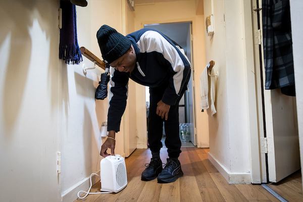 Older-man-adjusting-dehumidifier