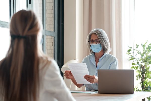 Older-woman-in-a-mask-at-a-job-interview