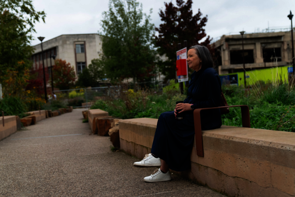 An older woman sitting on a bench