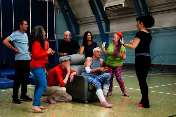 A group of people chat inside a circus