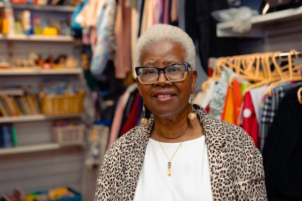 Older woman in charity shop with glasses