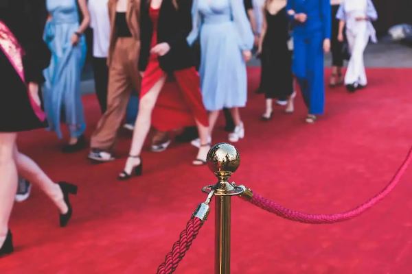 A photo of people walking down a red carpet