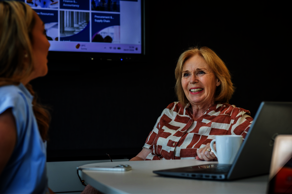An older woman at work in front of a laptop